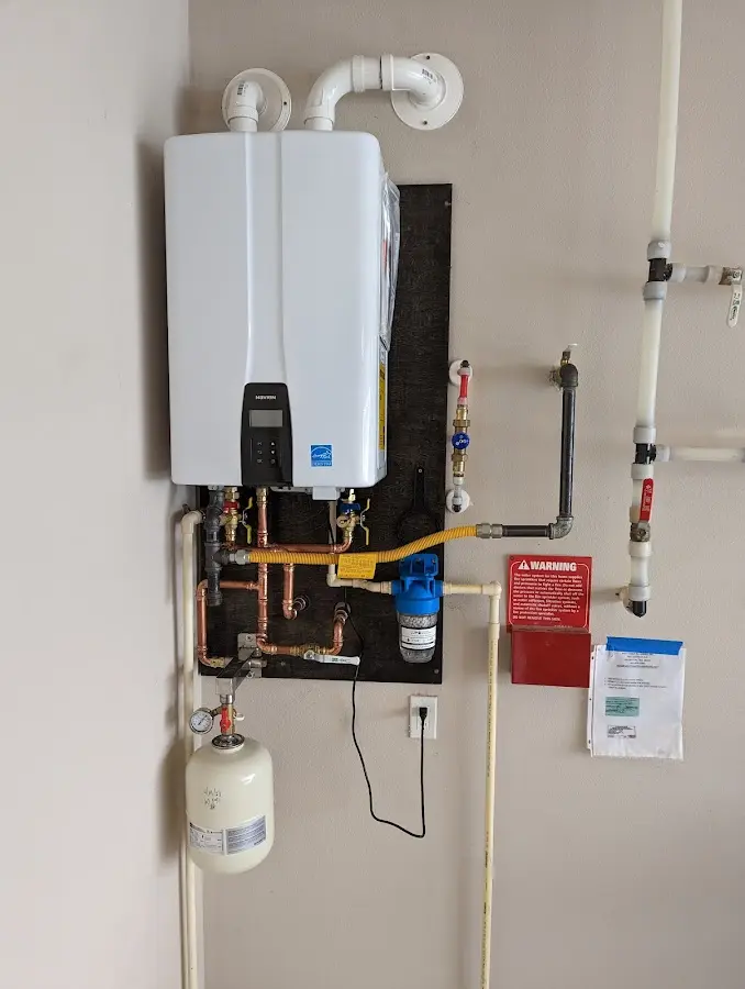 Professional plumber installing copper piping in a Halls home